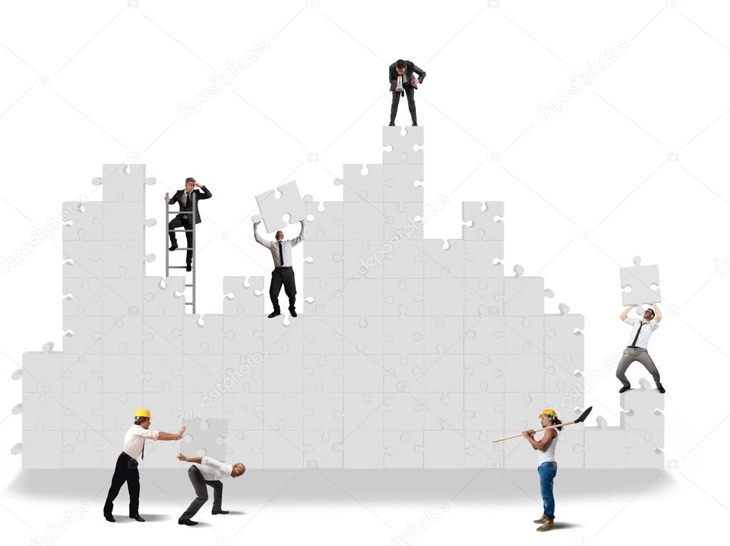 Business team working for the puzzle construction Stock Photo by  ©alphaspirit 72643851