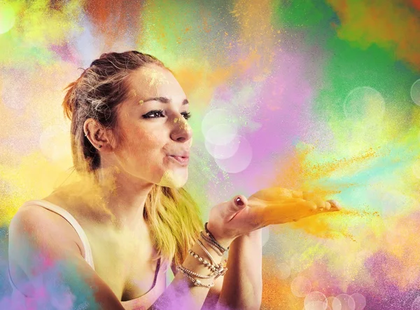 Girl blowing colored powders — Stock Photo, Image