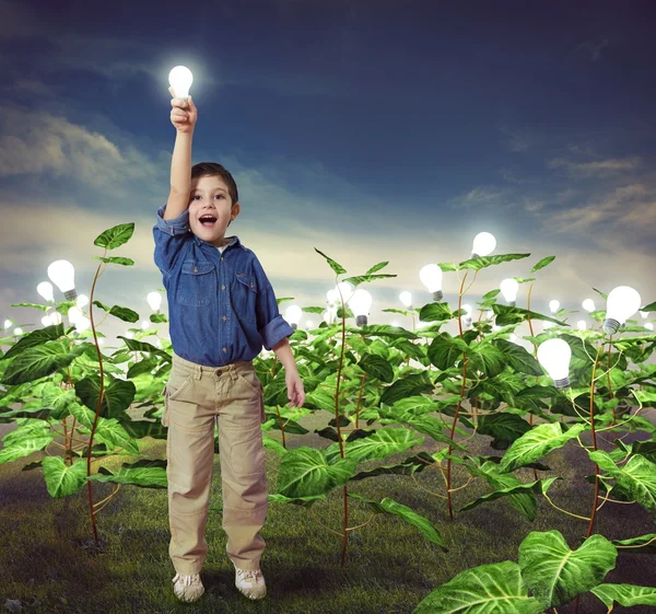 Little boy with light bulb — Stock Photo, Image