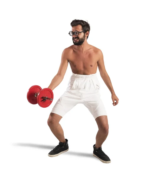 Nerdy guy lifts the weights — Stock Photo, Image