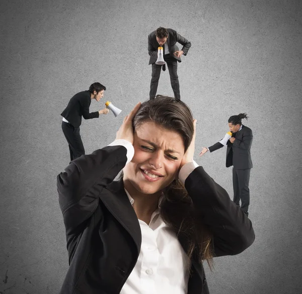 Employees yelling to a businesswoman — Stock Photo, Image