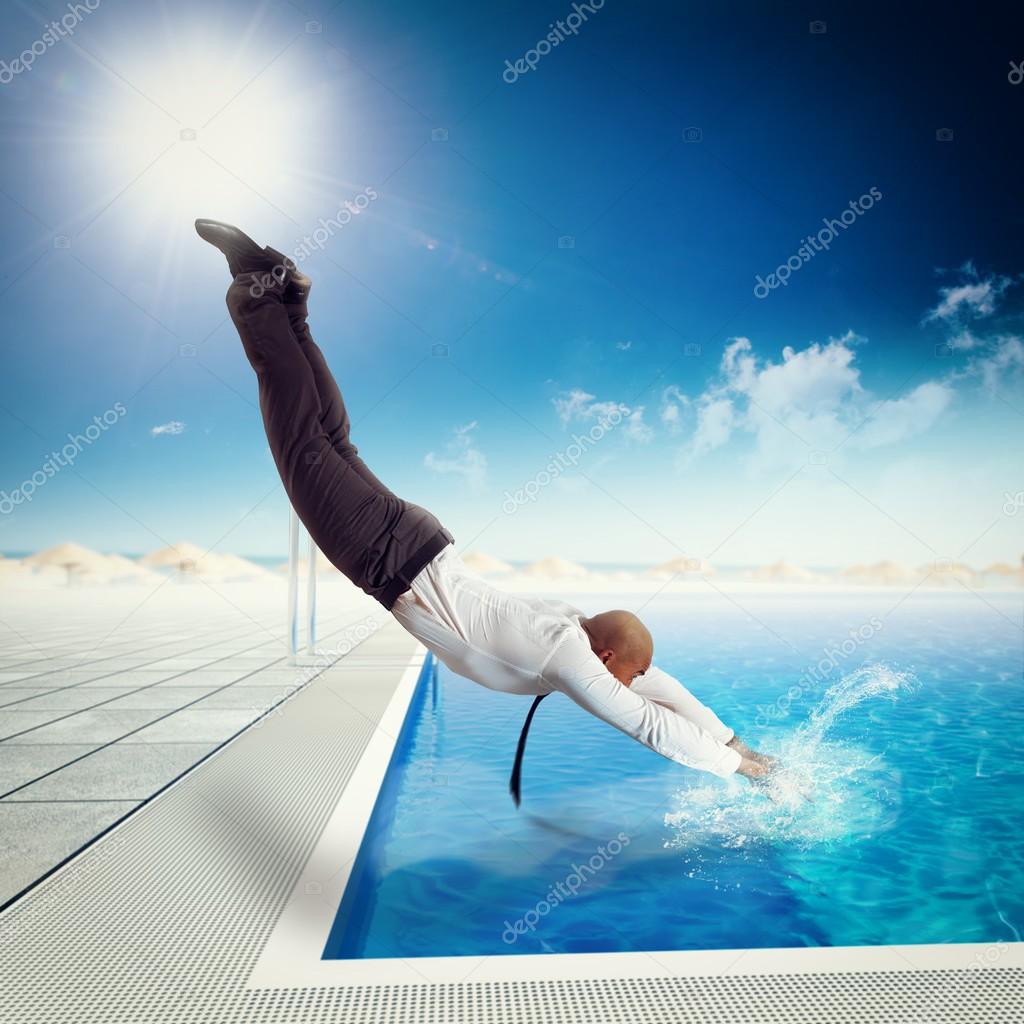 Businessman dives into the swimming pool