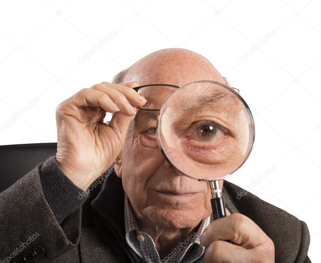 Elder man with magnifying glass