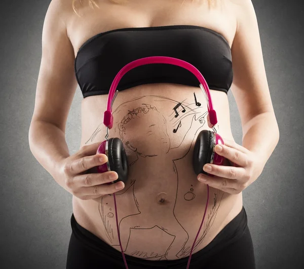 Unborn baby listen to music — Stock Photo, Image