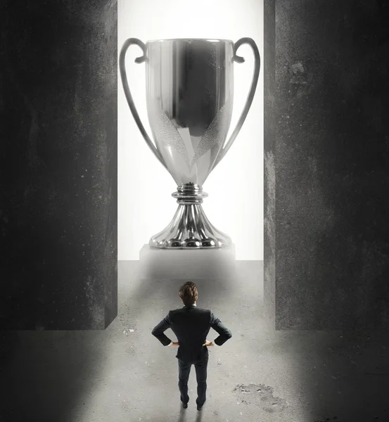 Businessman in front of a giant cup — Stock Photo, Image