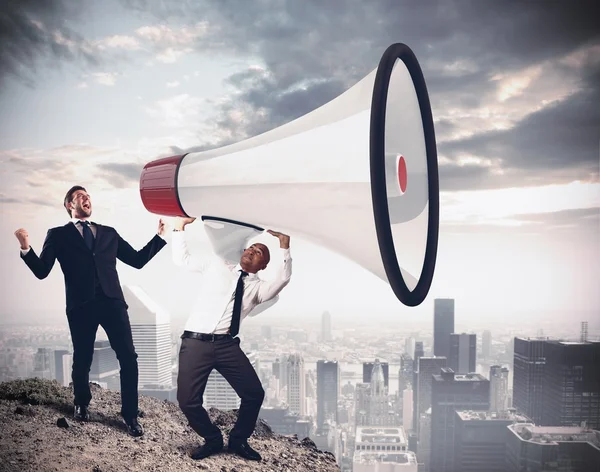 Businessman shouting into megaphone — Stock Photo, Image