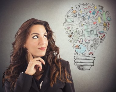 Businesswoman looking at a light bulb clipart