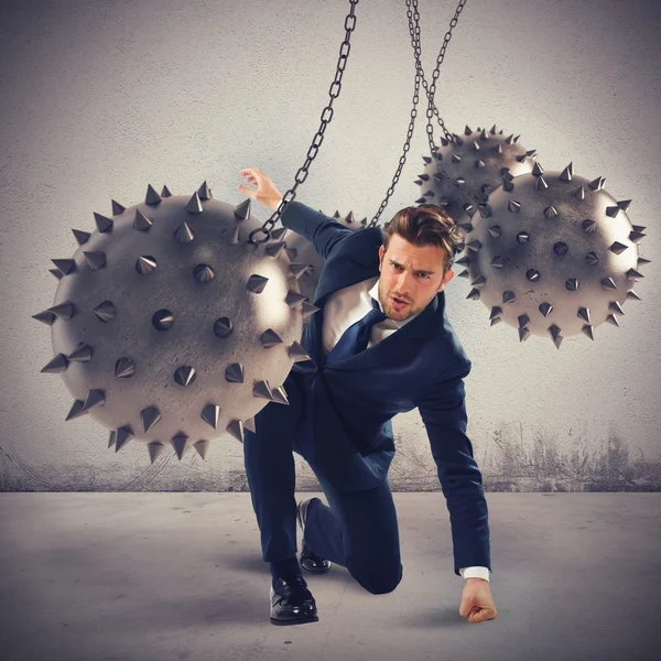 Businessman between fierce spiky balls — Stock Photo, Image