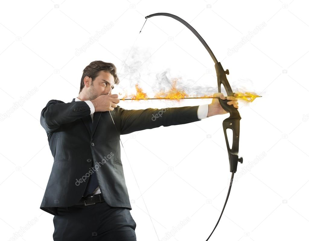 businessman with flaming arrow takes aim