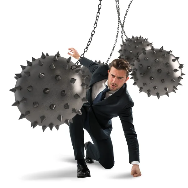 Businessman between fierce spiky balls — Stock Photo, Image