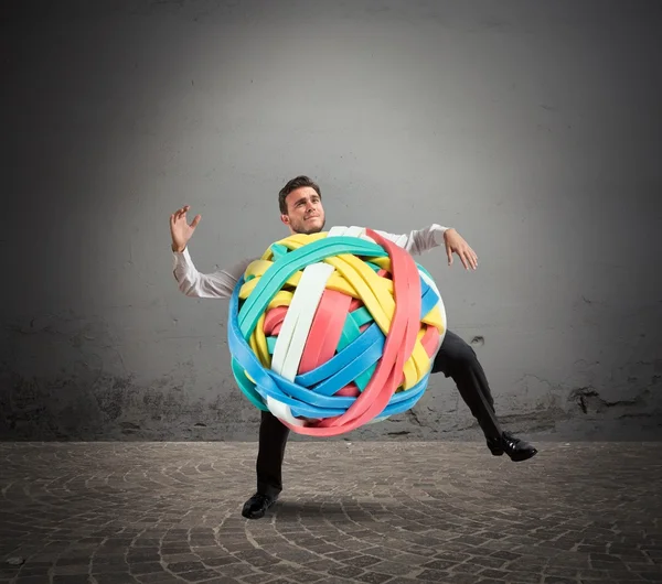 Businessman with a tangle of rubber bands — Stock Photo, Image