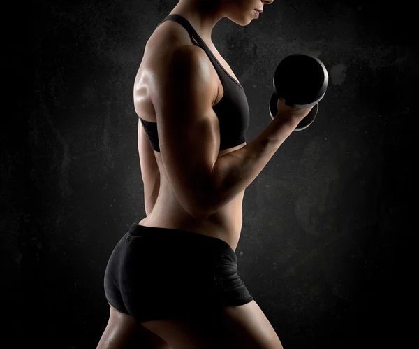 Athletic muscular woman with dumbbell — Stock Photo, Image