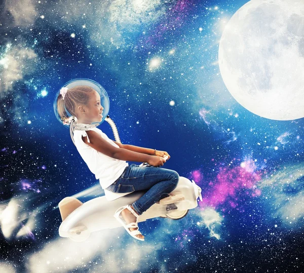 Little girl astronaut in space — Stock Photo, Image