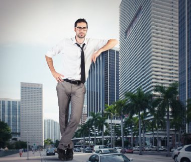 businessman leaning against a skyscraper clipart