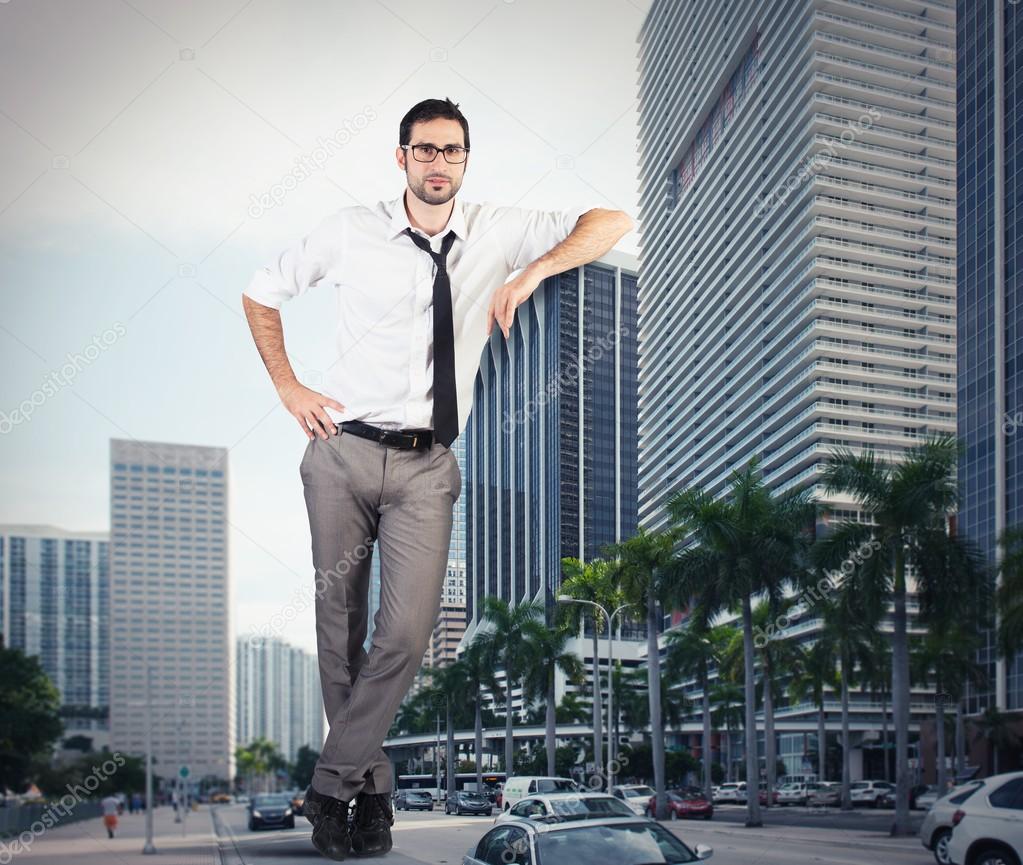 businessman leaning against a skyscraper