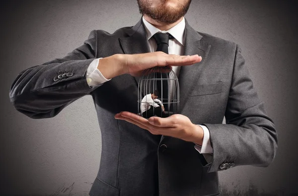 Boss holds caged businessmen — Stock Photo, Image