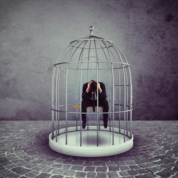 Businessman in a bird cage — Stock Photo, Image