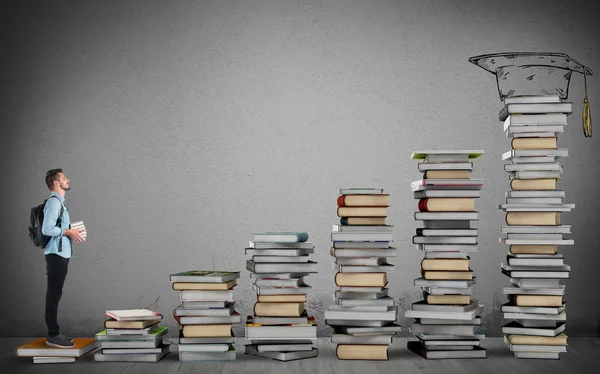 Student climbing a ladder of study — Stock Photo, Image