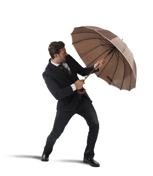 Businessman protect himself with umbrella — Stock Photo, Image