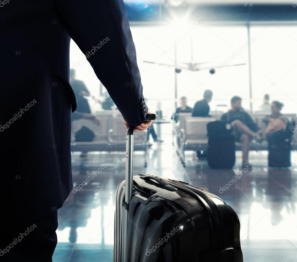 Passenger with suitcase in an airport