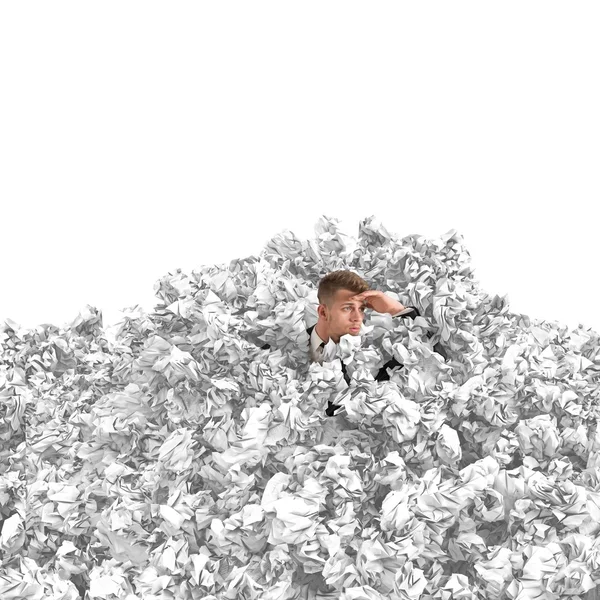 Businessman buried by balls of paper — Stock Photo, Image