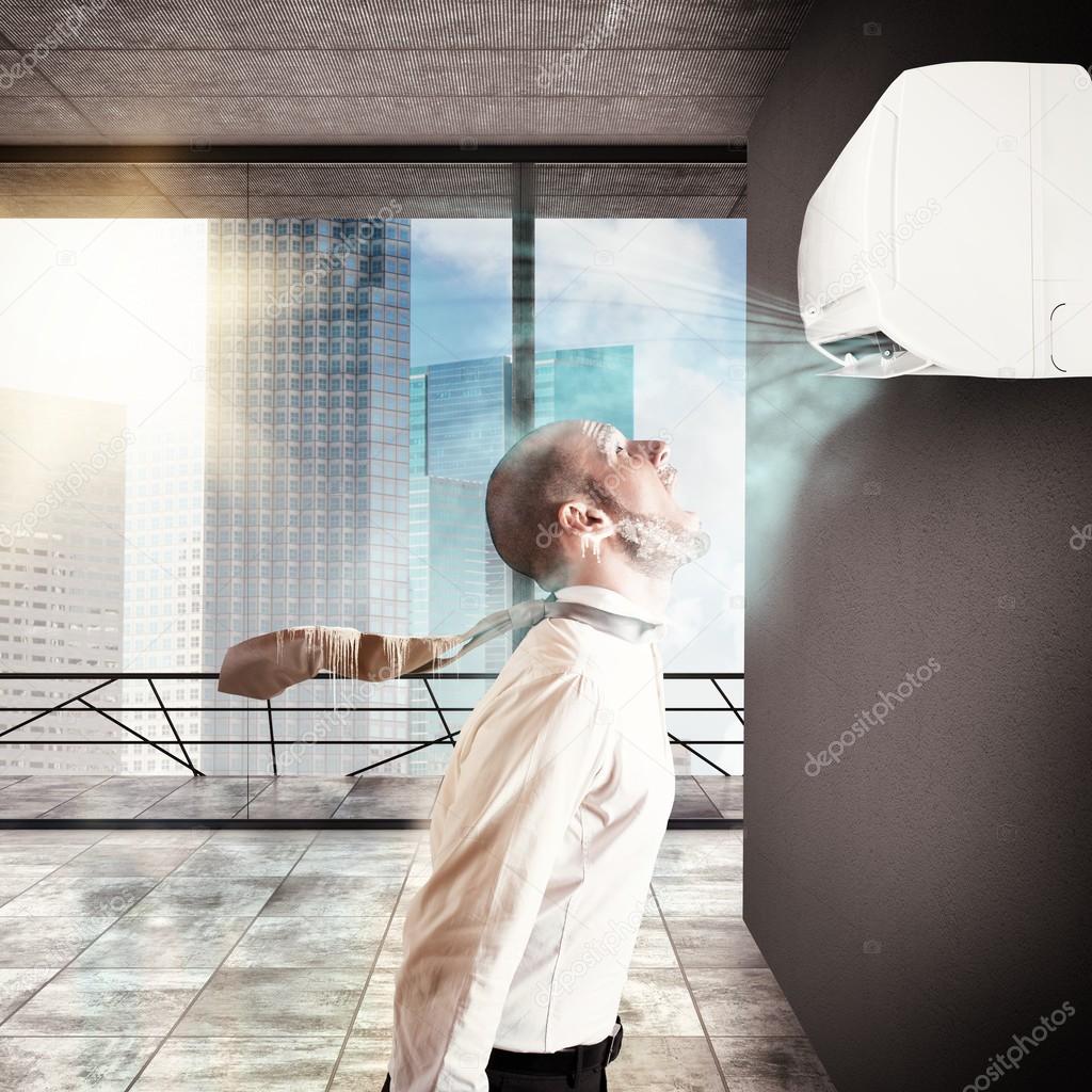 Businessman frozen by the air conditioner