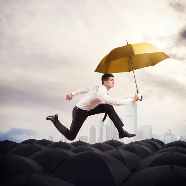 Man with yellow umbrella — Stock Photo, Image