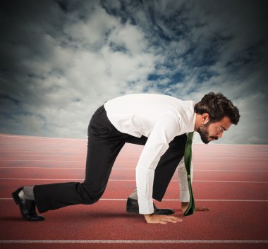 Businessman in position to start a race clipart
