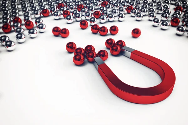 Magnet that attracts only the red balls — Stock Photo, Image