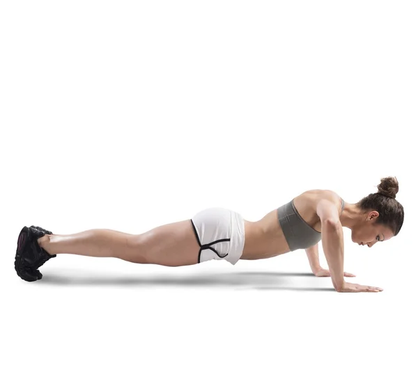 Athletic girl doing push up — Stock Photo, Image