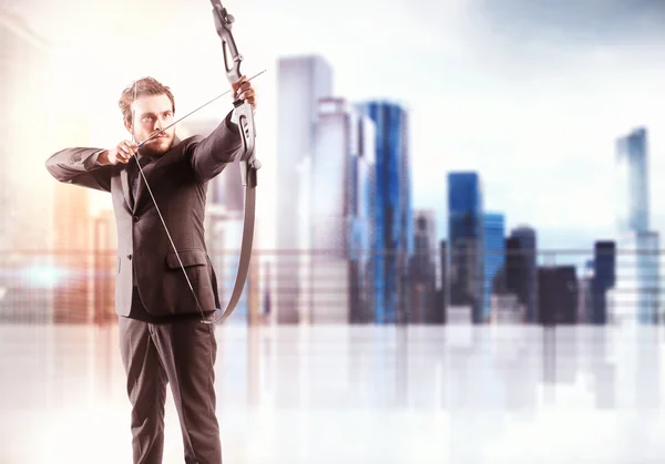 Businessman with bow pointing a target — Stock Photo, Image