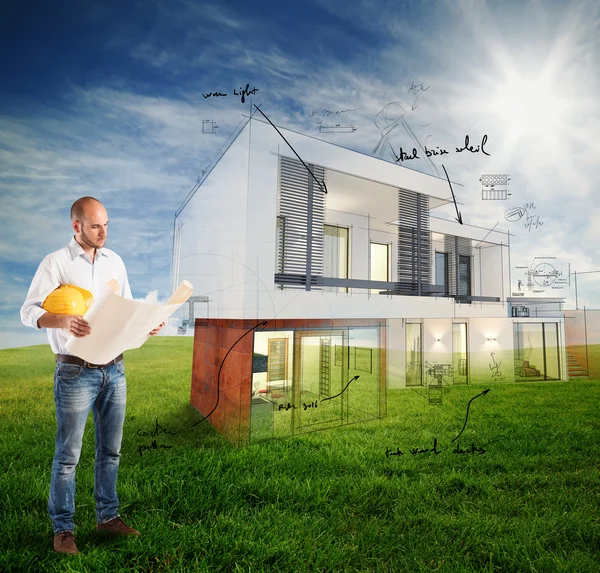 Architect looks at house project — Stock Photo, Image