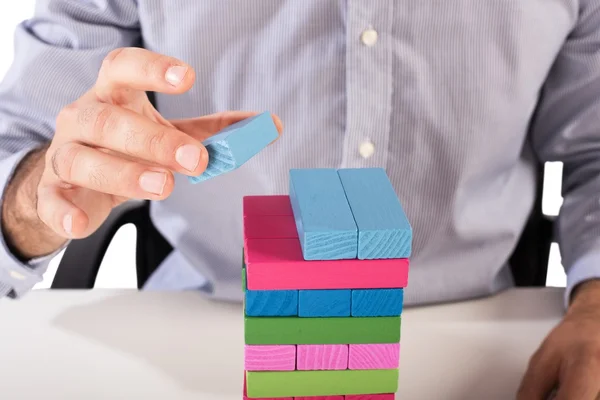 Businessman make a building with blocks — Stock Photo, Image