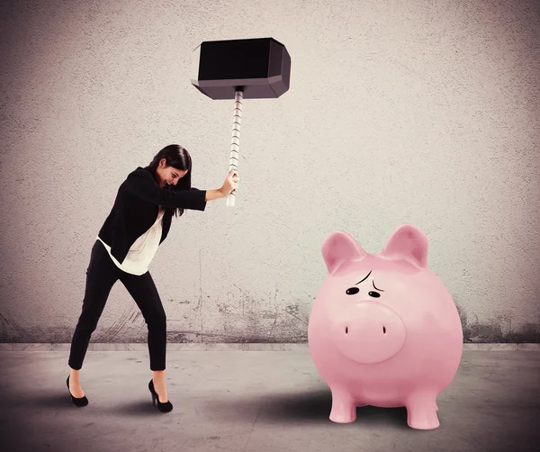 Woman breaks a piggybank — Stock Photo, Image