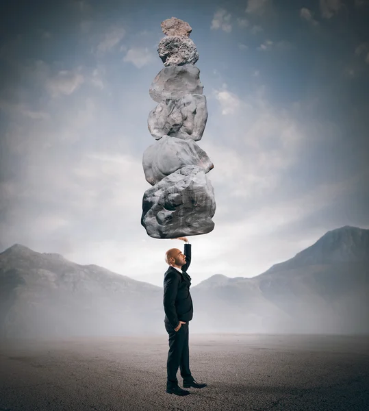 Businessman holds in one hand boulders stack — Stock Photo, Image