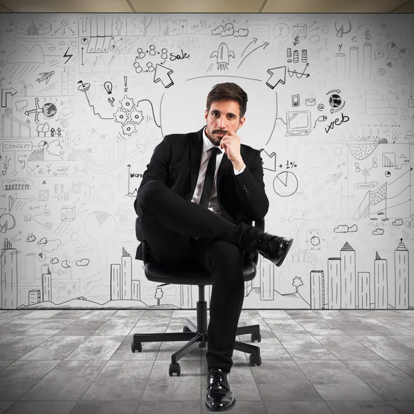 Confident businessman sitting on chair — Stock Photo, Image