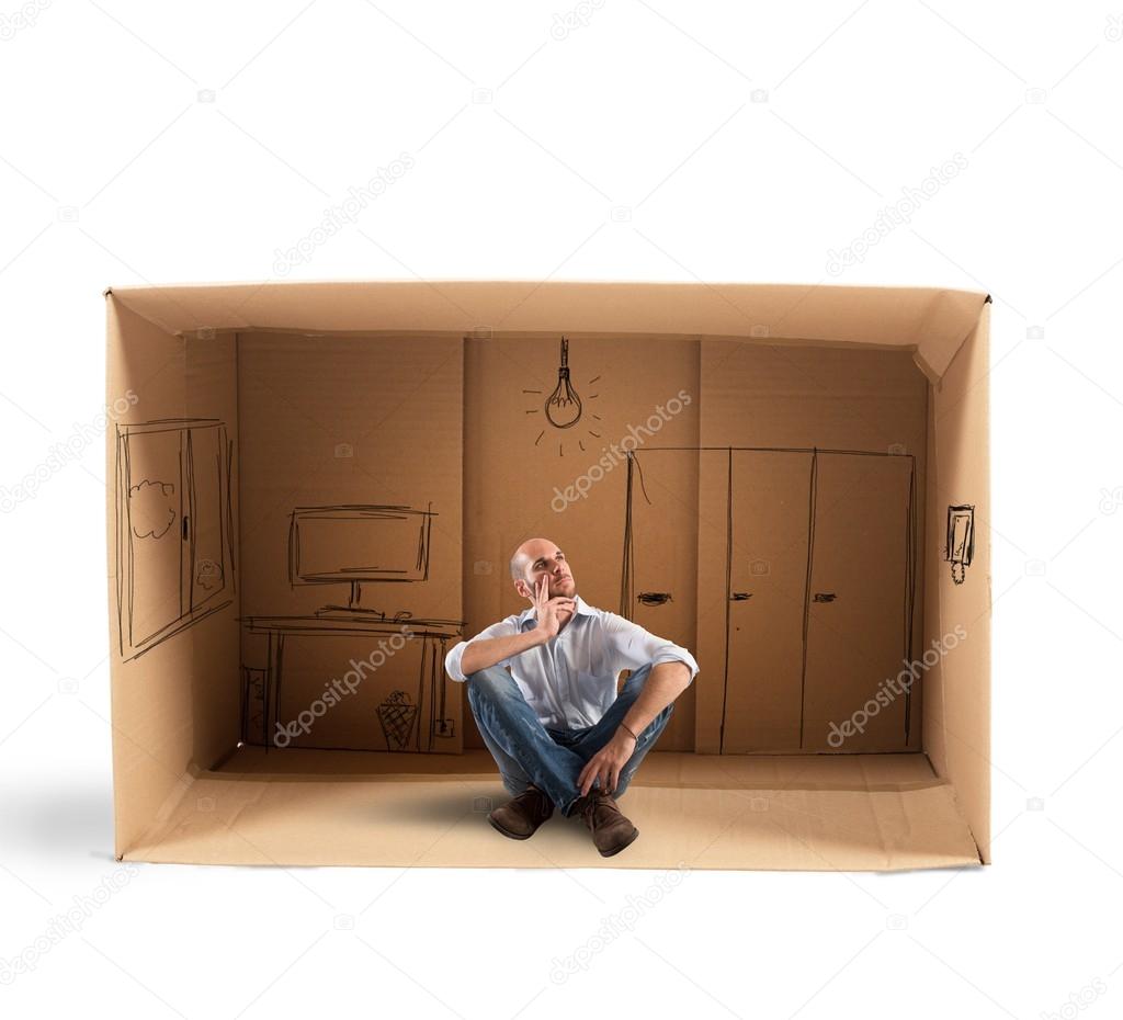 Businessman sitting in office designed in cardboard