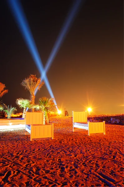 Beach of luxury hotel in night illumination on Palm Jumeirah man