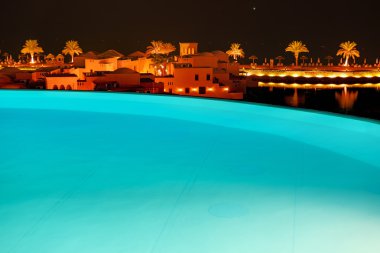 The swimming pool at luxury hotel in night illumination, Ras Al Khaima, UAE clipart