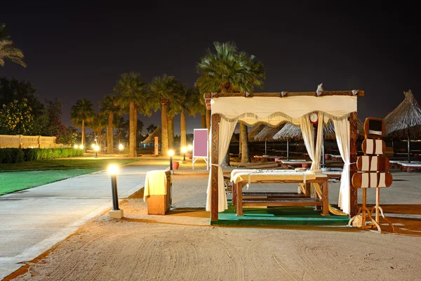 The massage beds on the beach in night illumination at the luxury hotel, Sharm el Sheikh, Egypt — Stock Photo, Image