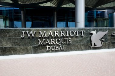 DUBAI, UAE - SEPTEMBER 10: The entrance of JW Marriott Marquis Dubai hotel on September 10, 2013 in Dubai, UAE. It is the worlds tallest hotel. clipart