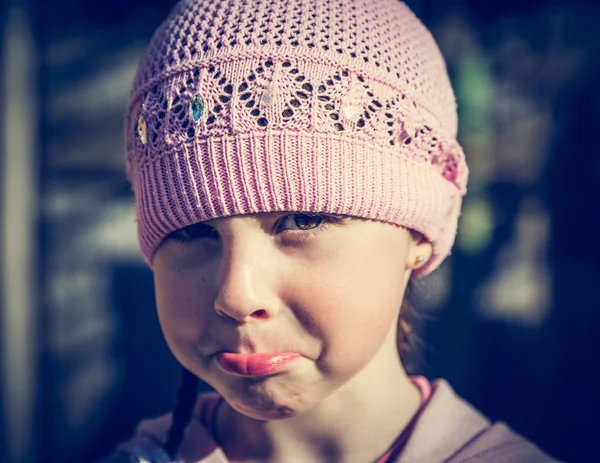 Close-up portrait of sad little girl with pursed lips. — Stock Photo, Image