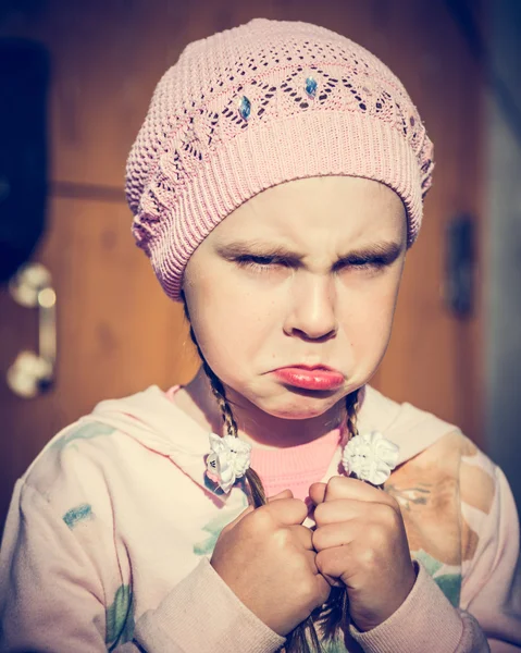 Close-up portrait of sad little girl with pursed lips. — Stock Photo, Image