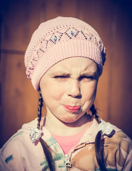 Close-up portrait of sad little girl with pursed lips. — Stock Photo, Image