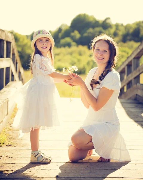 Daughter gives mother flowers. — Stock Photo, Image