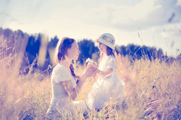 Tochter schenkt Mutter Blumen. — Stockfoto