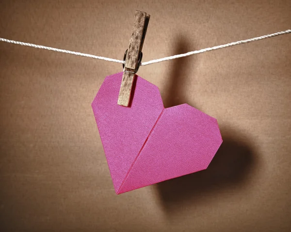 Paper heart hanging on a rope. — Stock Photo, Image