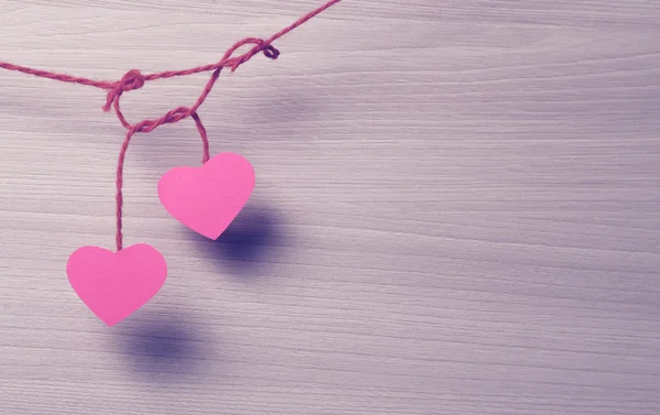 Two paper hearts hanging on a rope. — Stock Photo, Image