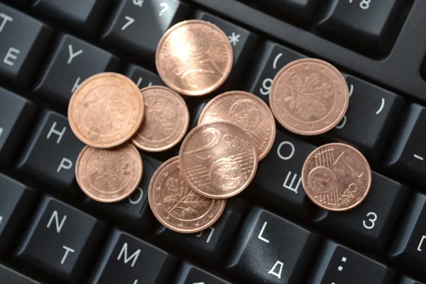 Coins on the keyboard - abstract business background — Stock Photo, Image