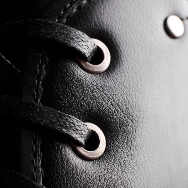 Zapatillas negras en bota Fotos de stock libres de derechos